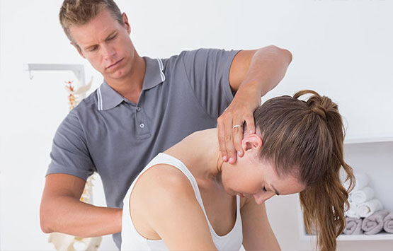 Chiroprator at Encinitas Auto Accident Injury Center in Encinitas adjusting female patient's neck to relieve whiplash effects