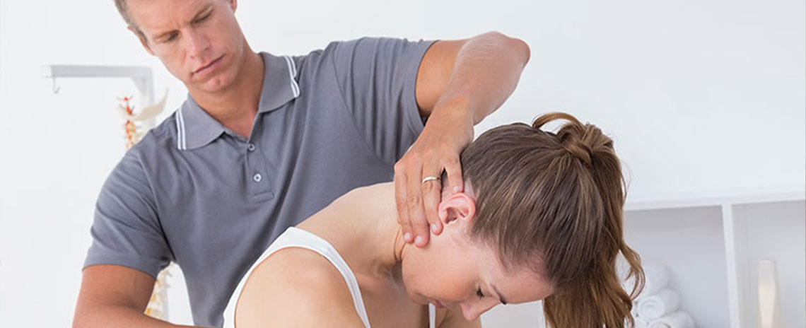 Chiroprator at Encinitas Auto Accident Injury Center in Encinitas adjusting female patient's neck to relieve whiplash effects