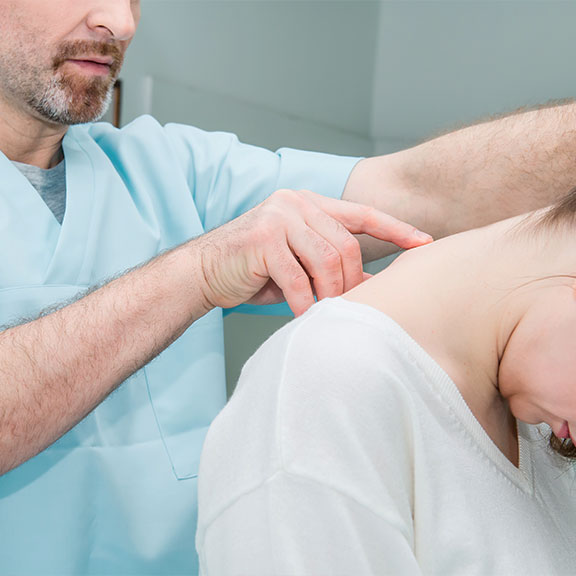 Patient receiving chiropractic consultation for whiplash at Encinitas Auto Accident Injury Center in Encinitas