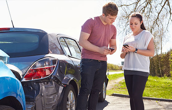 Man and woman exchanging info following an auto collision in Encinitas