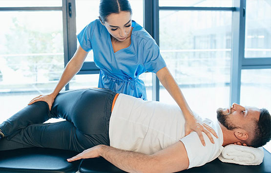 Male patient receiving chiropractic treatment for sciatica at Encinitas Auto Accident Injury Center in Encinitas